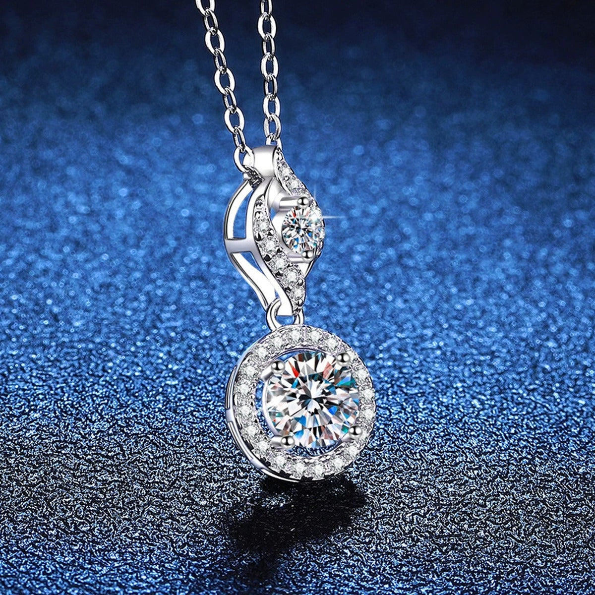 Double Halo Drop Moissanite Pendant Necklace in Platinum-Plated S925 Sterling Silver blue background angled view
