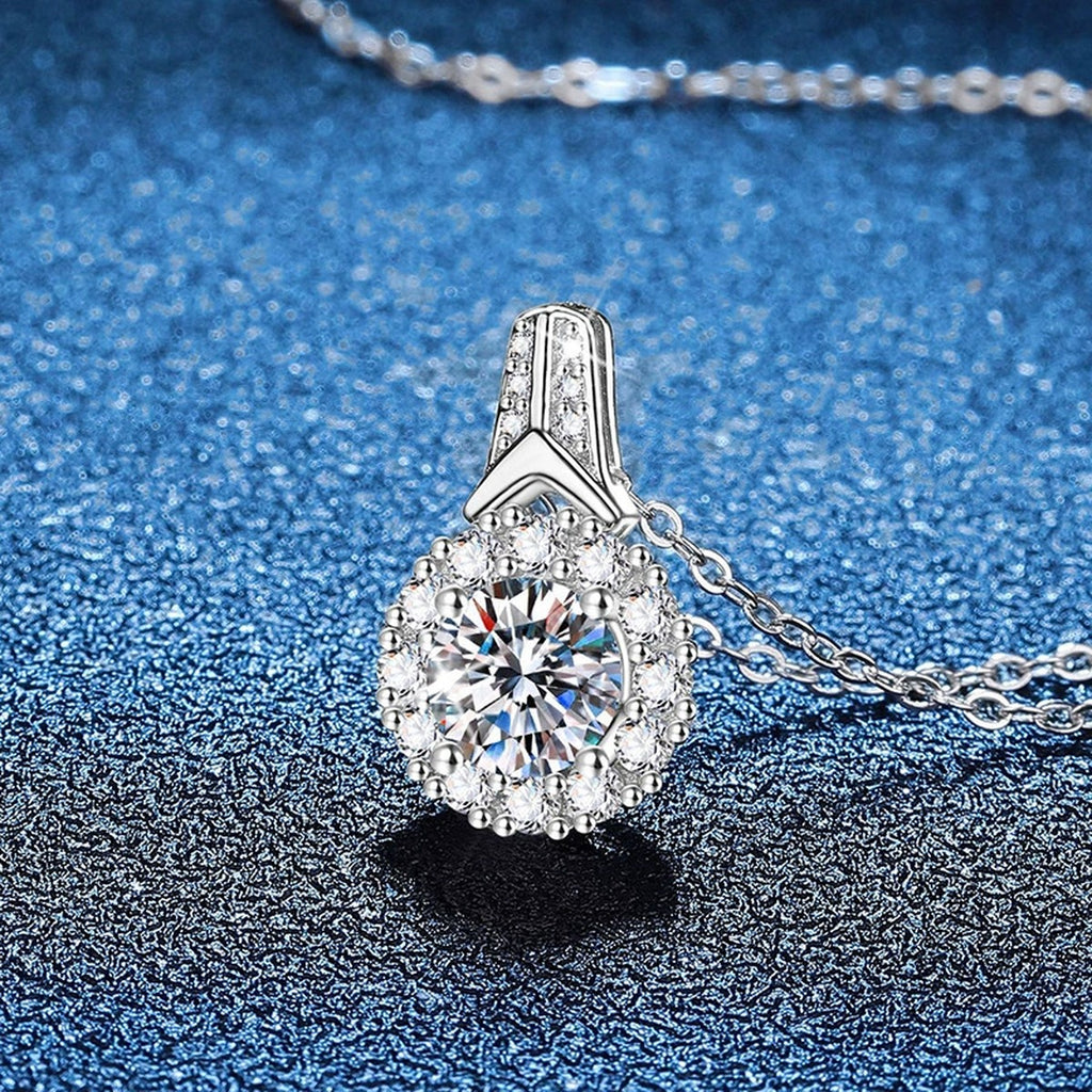 Round Halo Moissanite Pendant Necklace in Platinum-Plated S925 Sterling Silver blue background angled view