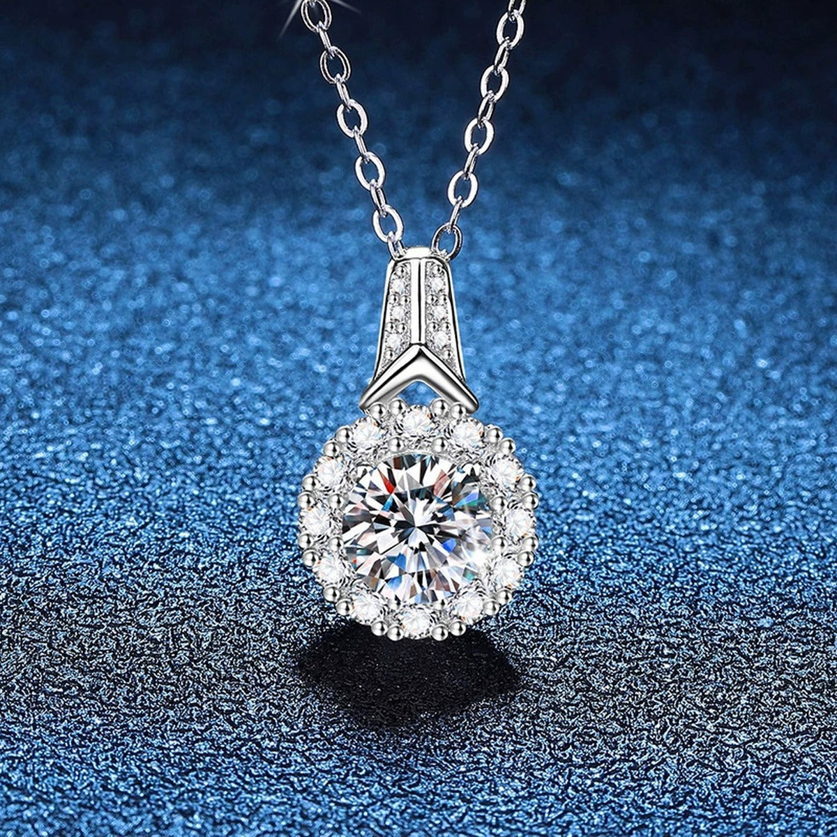 Round Halo Moissanite Pendant Necklace in Platinum-Plated S925 Sterling Silver blue background close-up view