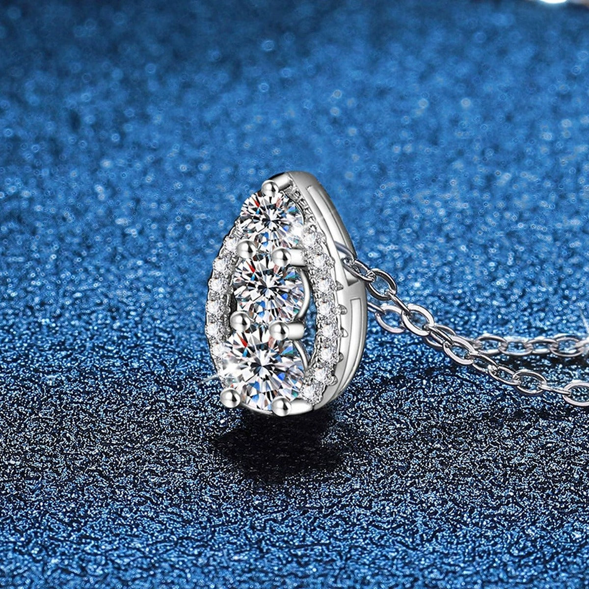 Teardrop Cluster Moissanite Pendant Necklace in Platinum-Plated S925 Sterling Silver blue background angled view