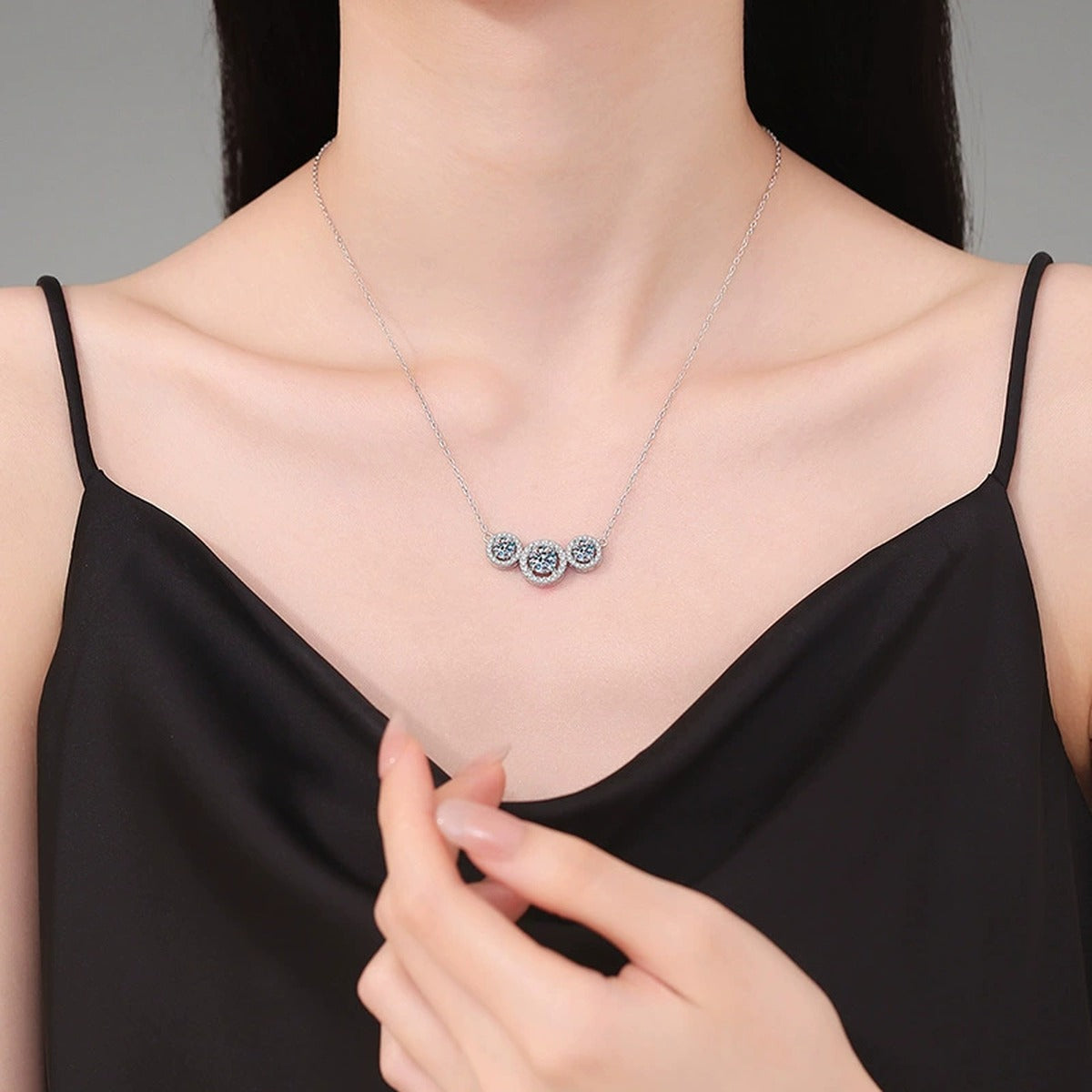 Three-Stone Halo Moissanite Station Necklace in Platinum-Plated S925 Sterling Silver worn on neckline by model