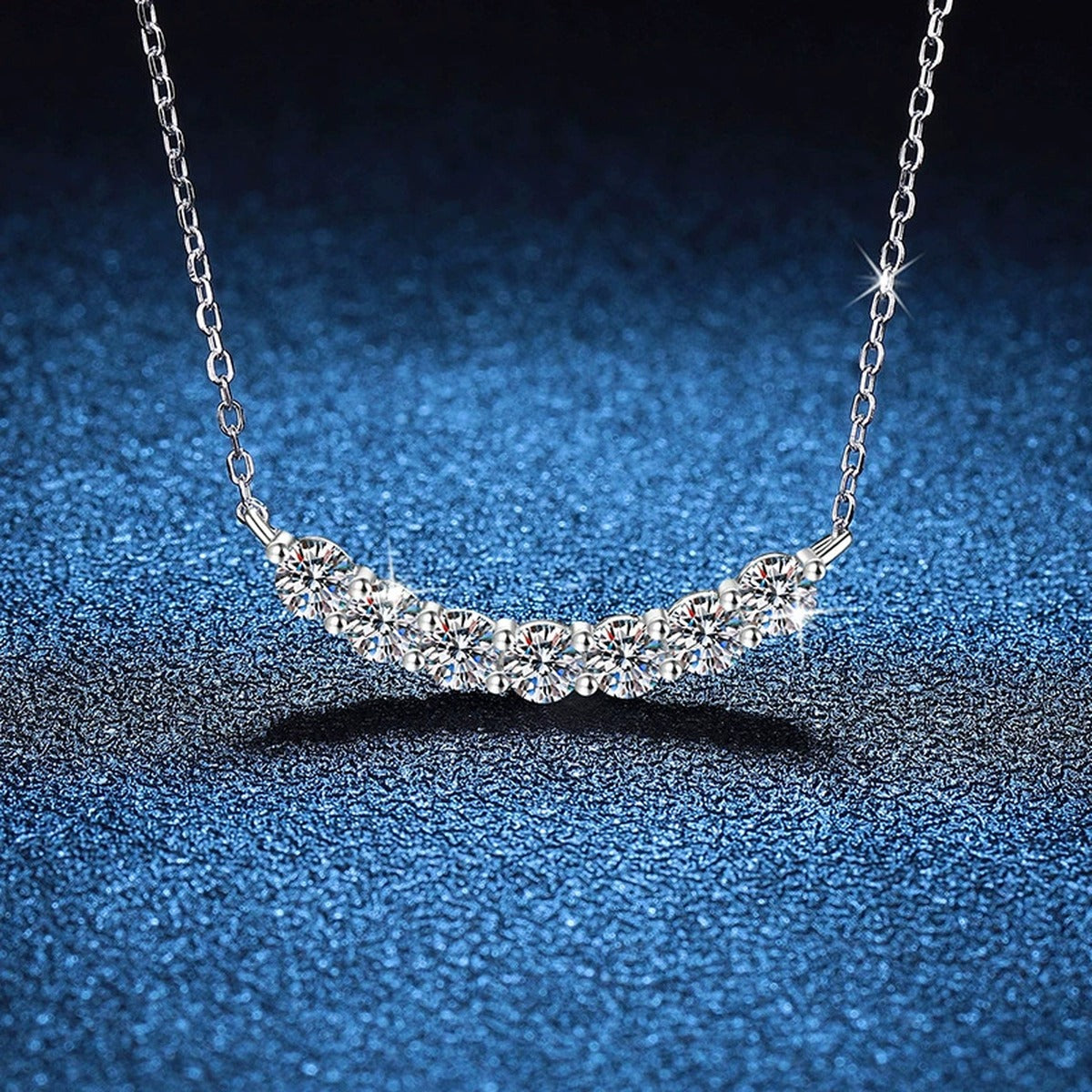 Graduated Moissanite Collar Necklace in Platinum-Plated S925 Sterling Silver blue background angled view