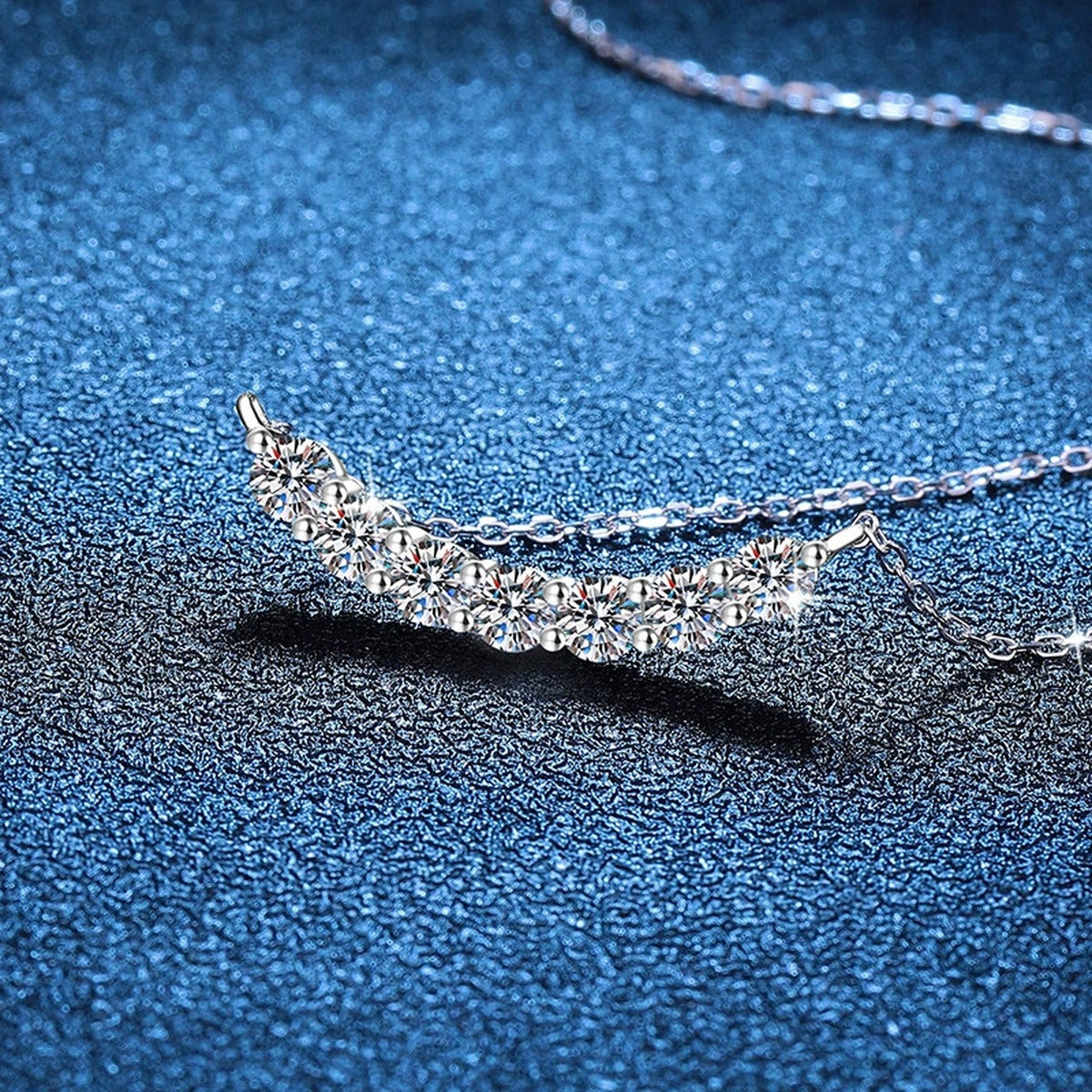 Graduated Moissanite Collar Necklace in Platinum-Plated S925 Sterling Silver blue background close-up view