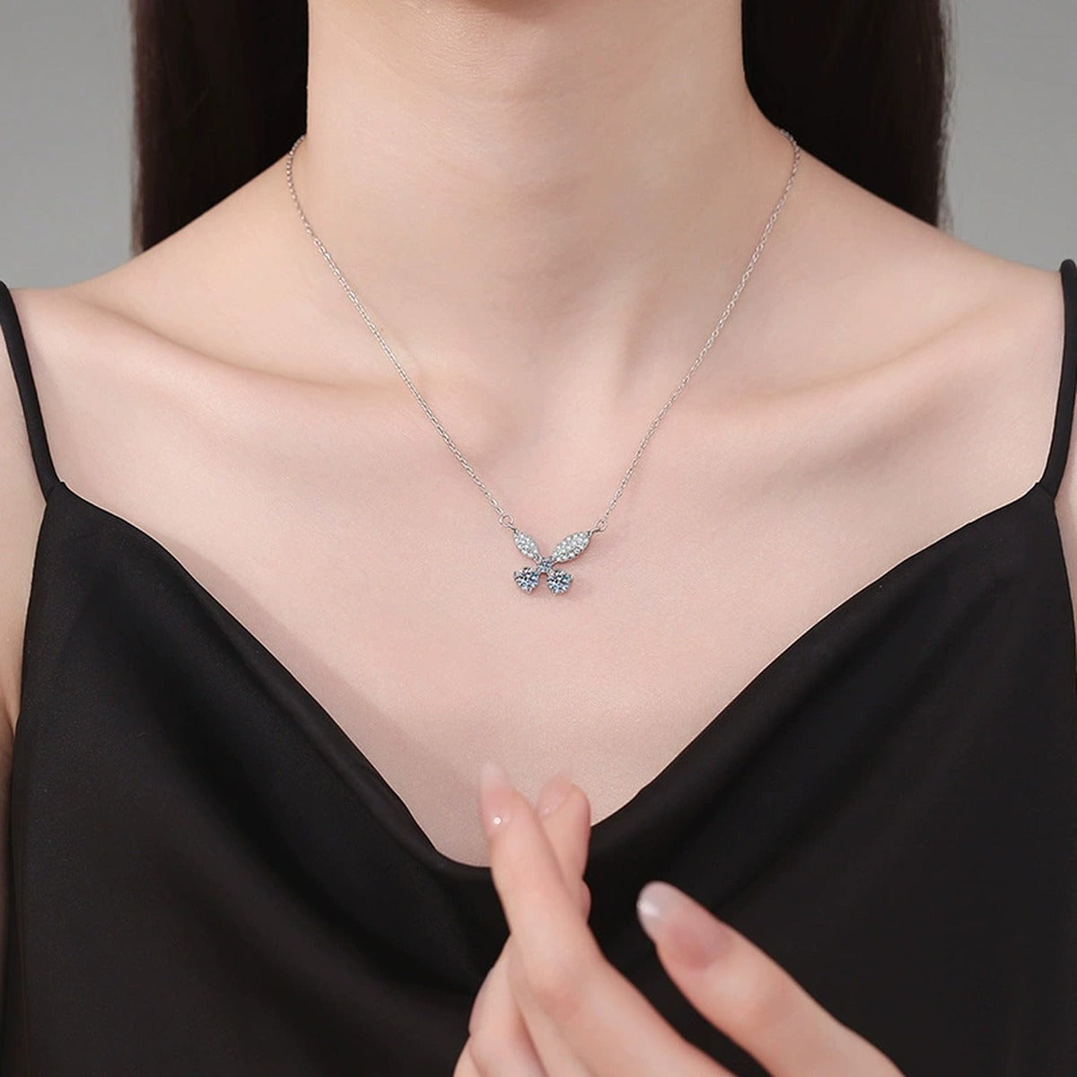 Butterfly Bow Moissanite Pendant Necklace in Platinum-Plated S925 Sterling Silver worn on neckline by model