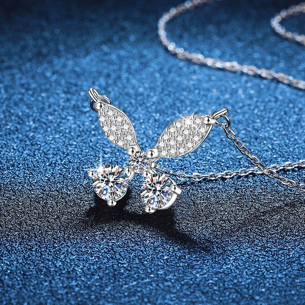 Butterfly Bow Moissanite Pendant Necklace in Platinum-Plated S925 Sterling Silver blue background close-up view