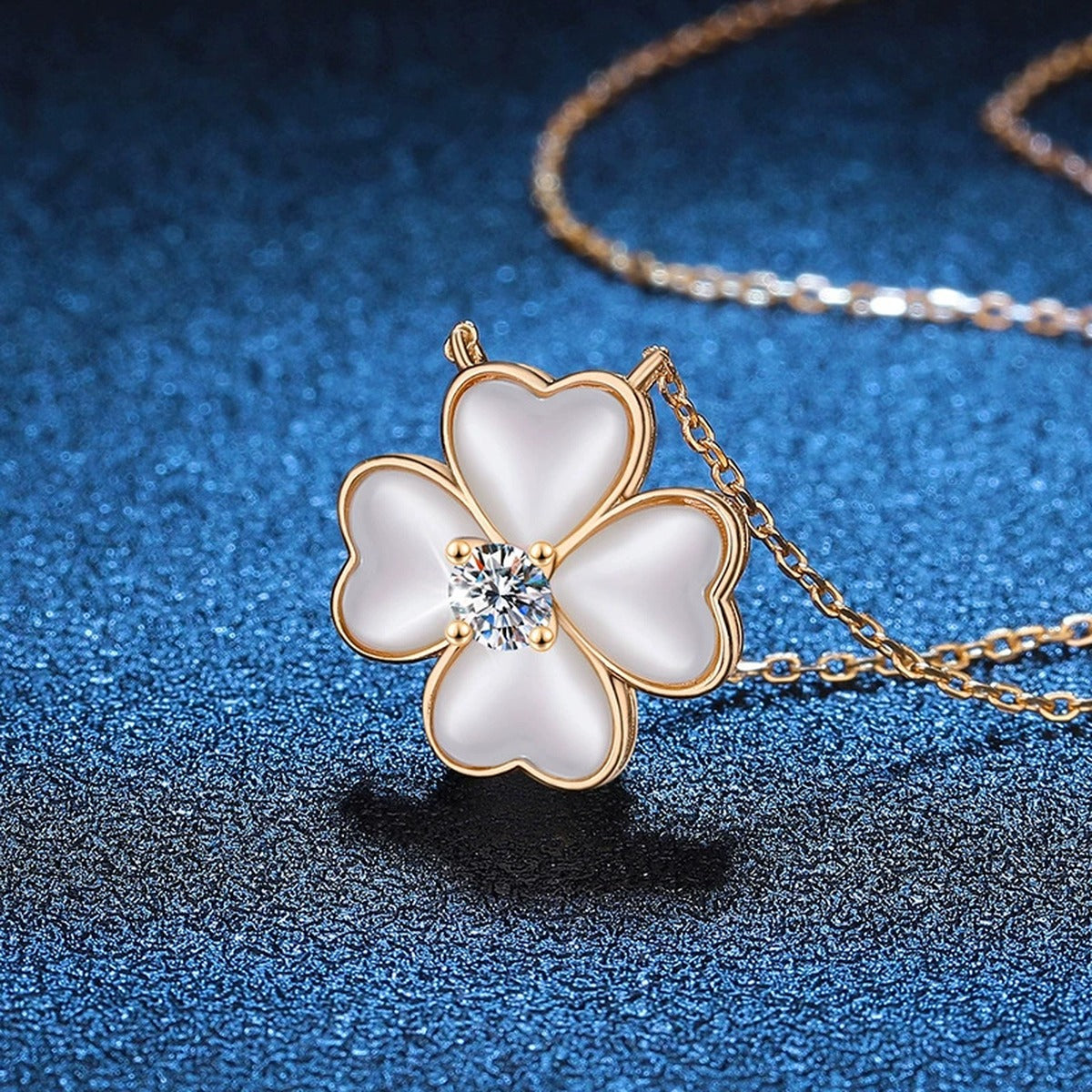 White Mother-of-Pearl Clover Moissanite Pendant Necklace in Champagne Gold-Plated S925 Sterling Silver blue background angled view