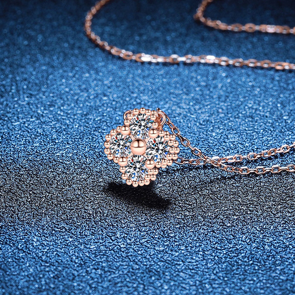 Four-Stone Clover Moissanite Pendant Necklace in S925 Sterling Silver blue background angled view
