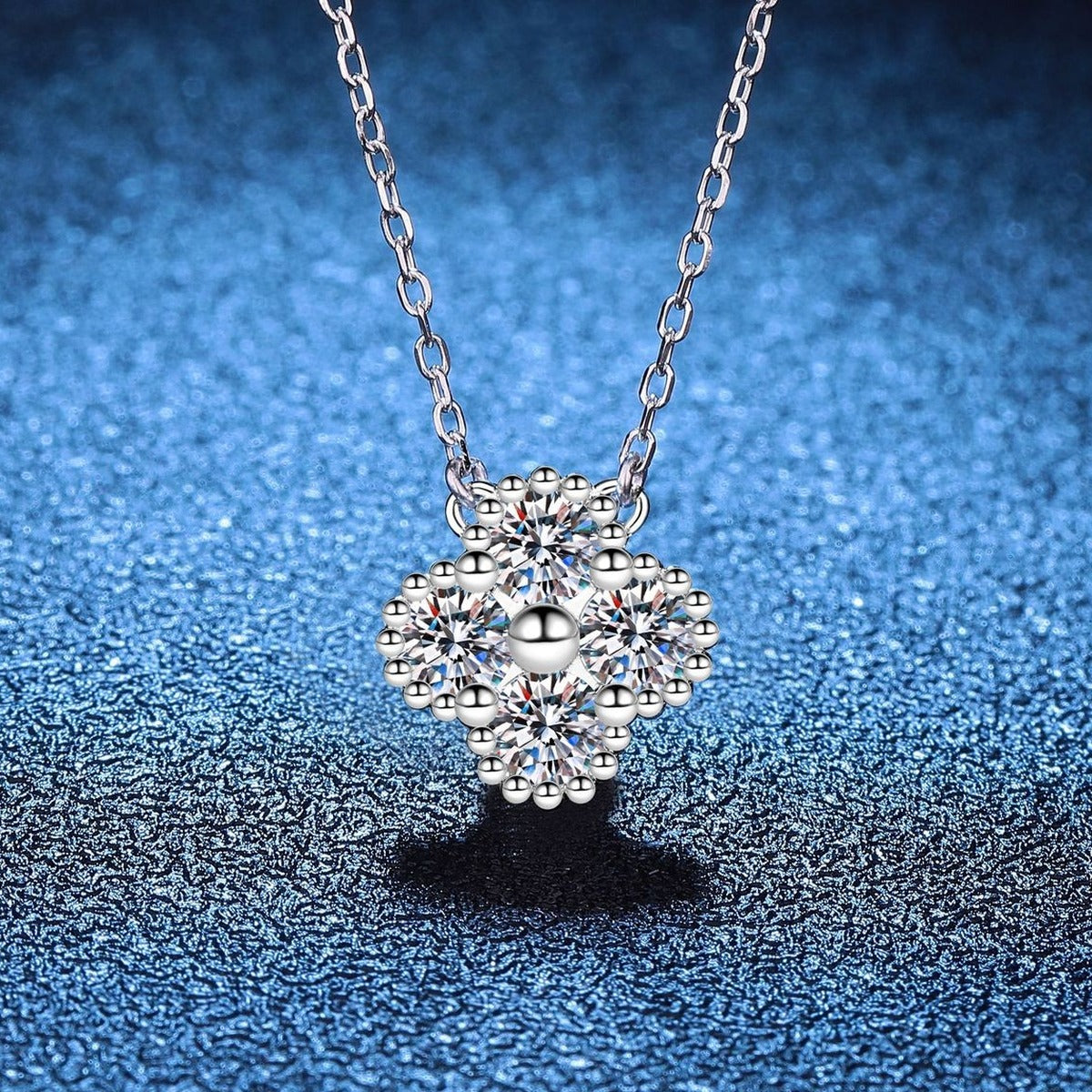 Four-Stone Clover Moissanite Pendant Necklace in S925 Sterling Silver blue background styling view