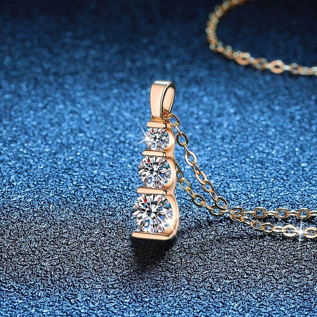 Vertical Three-Stone Moissanite Bar Necklace in 14K Yellow Gold-Plated S925 Sterling Silver blue background angled view