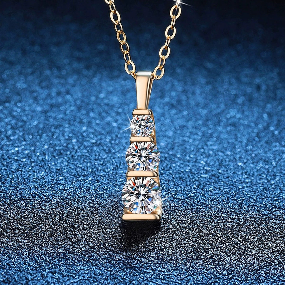 Vertical Three-Stone Moissanite Bar Necklace in 14K Yellow Gold-Plated S925 Sterling Silver blue background close-up view