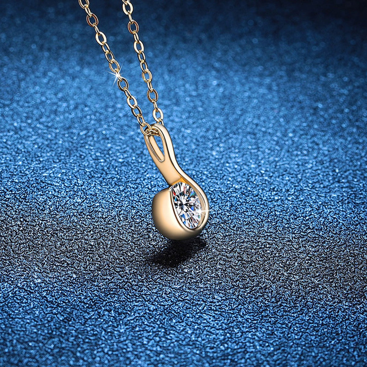 Curved Loop Moissanite Pendant Necklace in S925 Sterling Silver blue background styling view