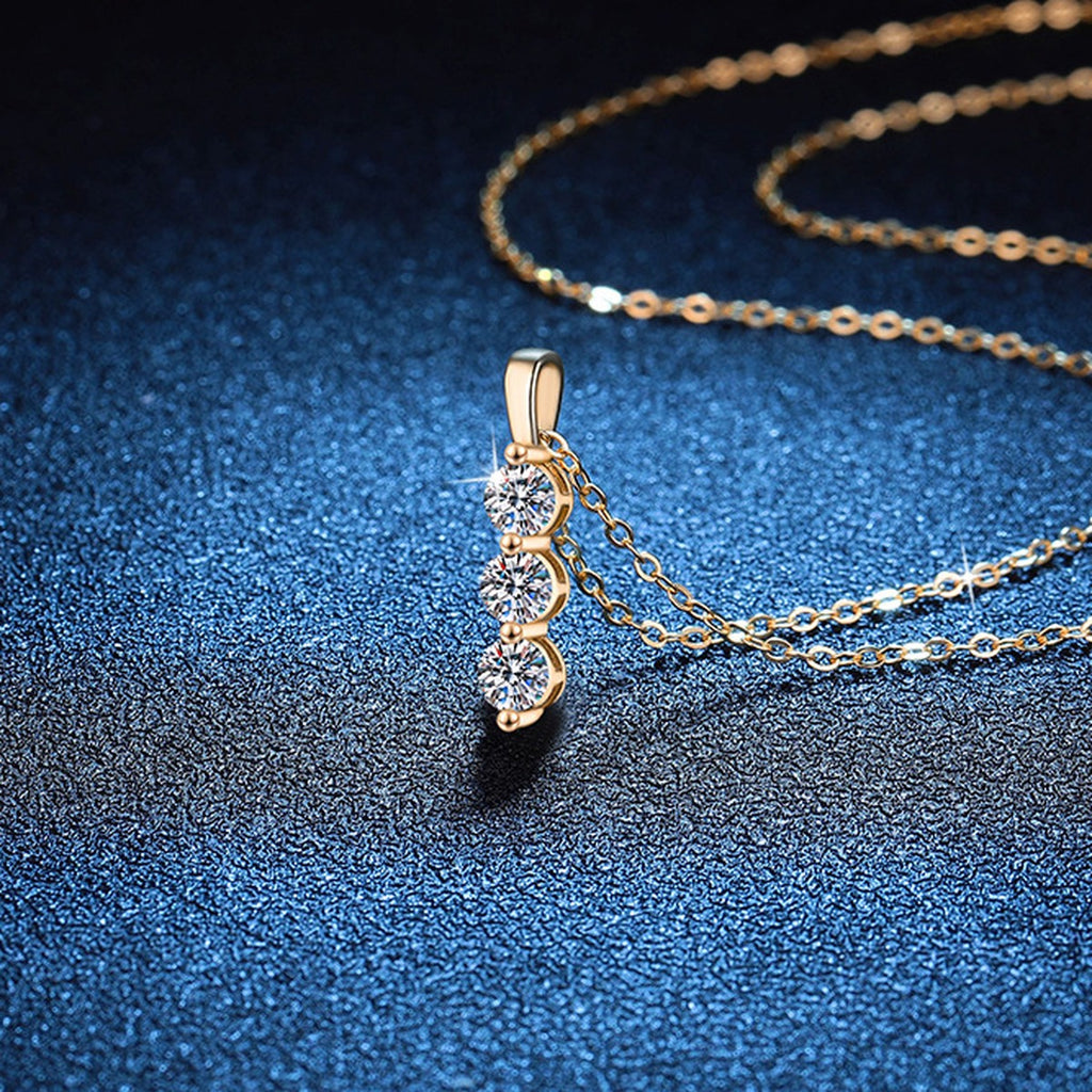 Vertical Three-Stone Moissanite Drop Necklace in S925 Sterling Silver blue background close-up view