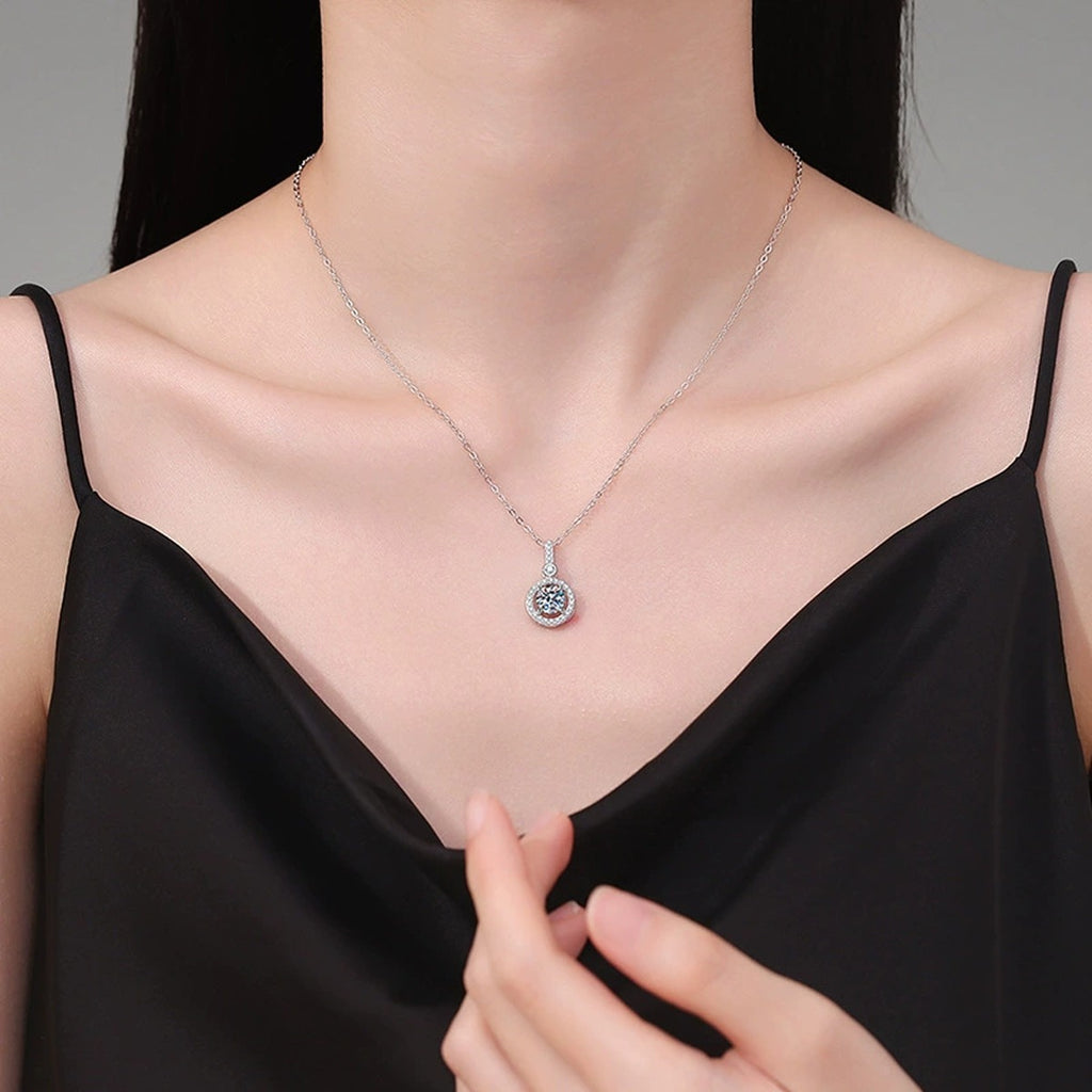 Round Halo Drop Moissanite Pendant Necklace in Platinum-Plated S925 Sterling Silver worn on neckline by model