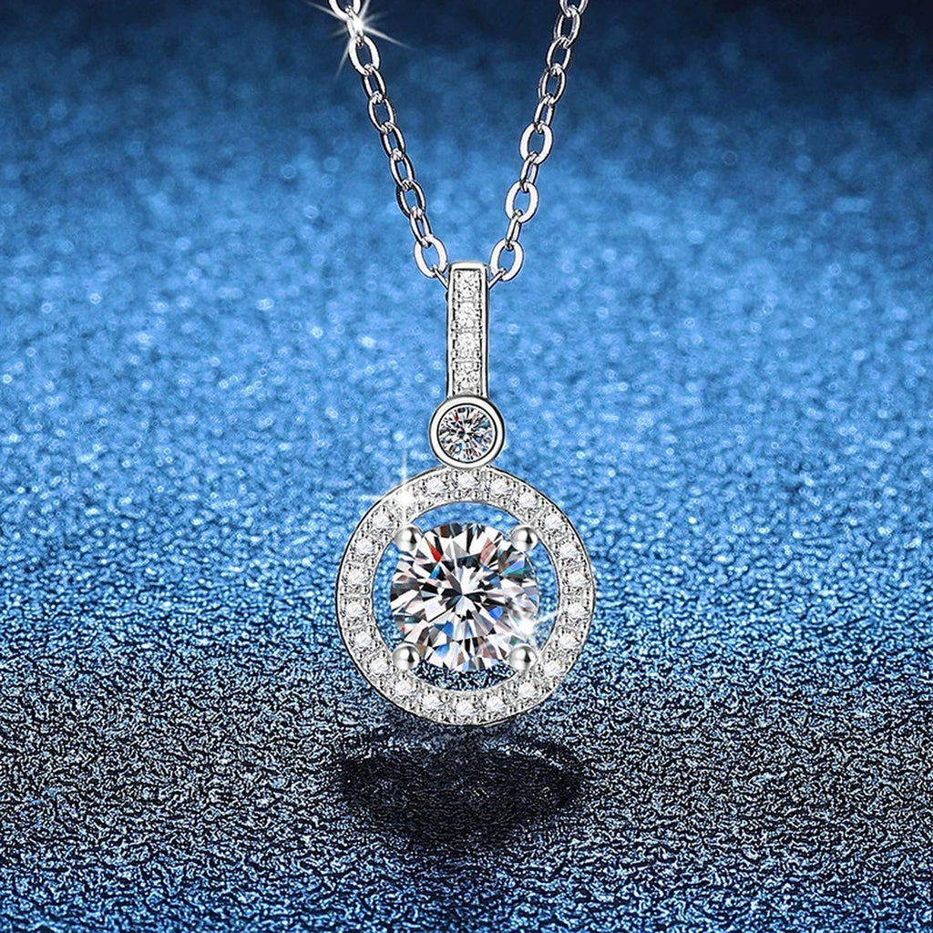 Round Halo Drop Moissanite Pendant Necklace in Platinum-Plated S925 Sterling Silver blue background angled view
