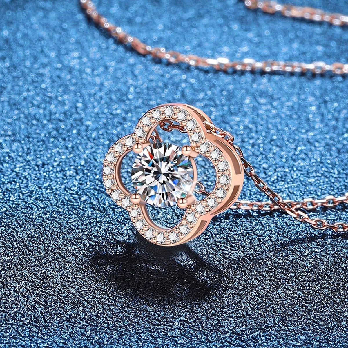 Clover Halo Moissanite Pendant Necklace in Rose Gold-Plated S925 Sterling Silver blue background angled view