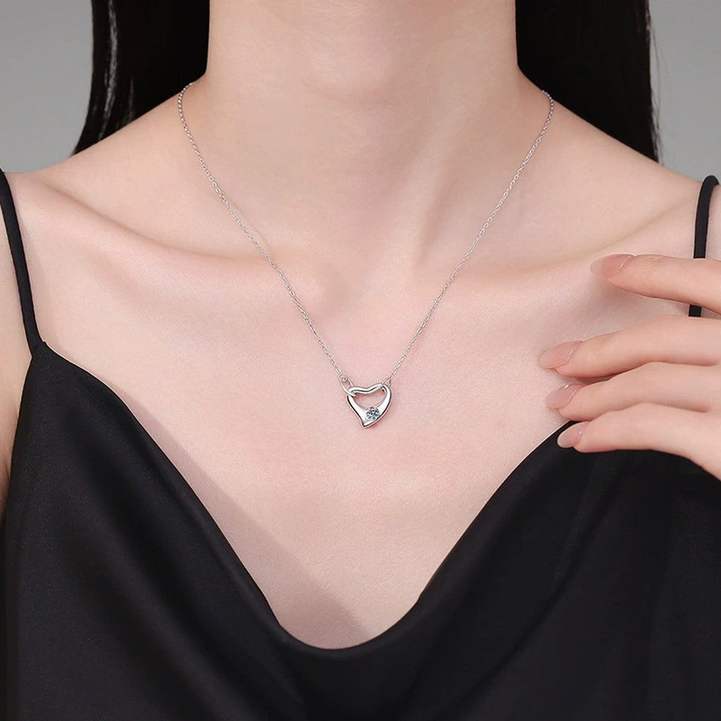 Open Heart Knot Moissanite Pendant Necklace in Platinum-Plated S925 Sterling Silver worn on neckline by model