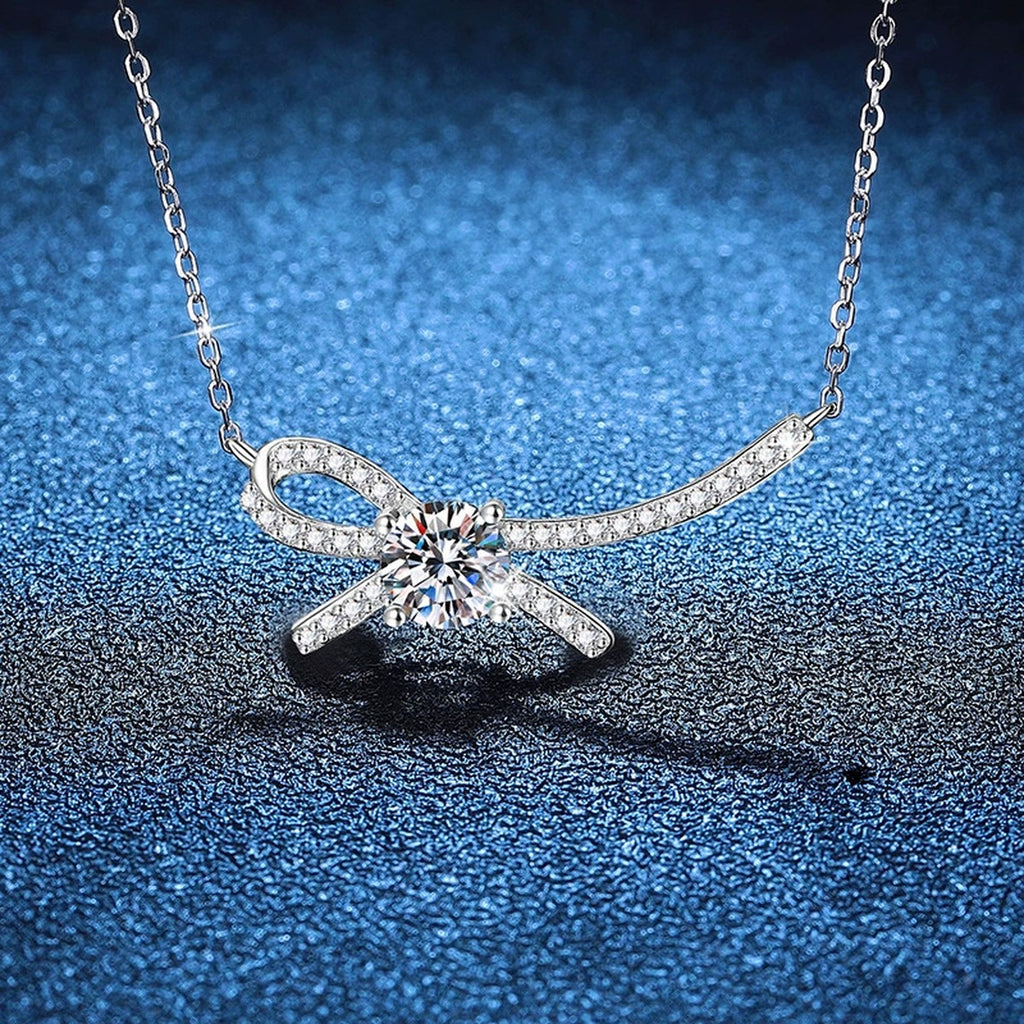 Ribbon Bow Moissanite Collar Necklace in Platinum-Plated S925 Sterling Silver blue background close-up view