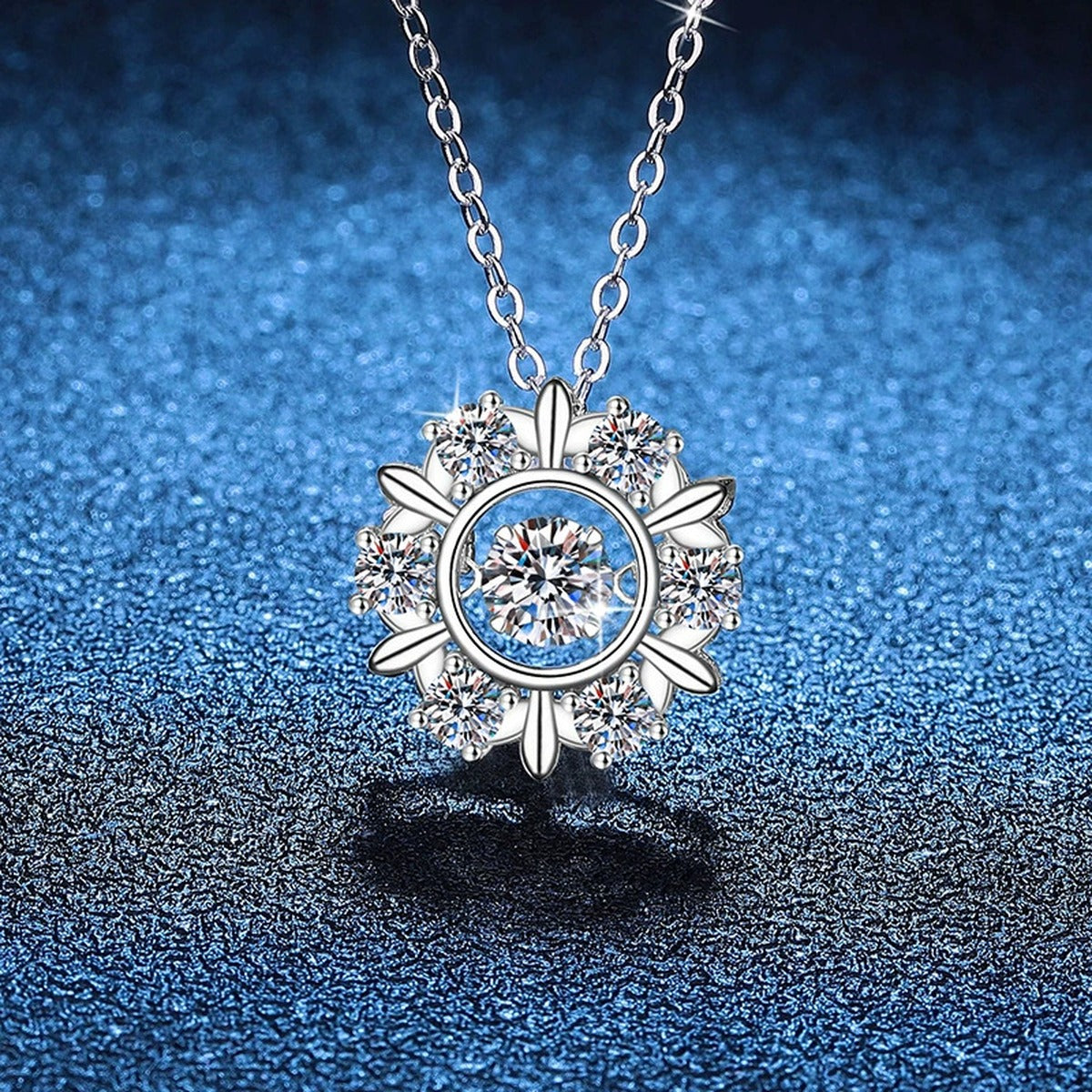 Sunburst Halo Moissanite Pendant Necklace with Cubic Zirconia Side Stones in Platinum-Plated S925 Sterling Silver blue background angled view