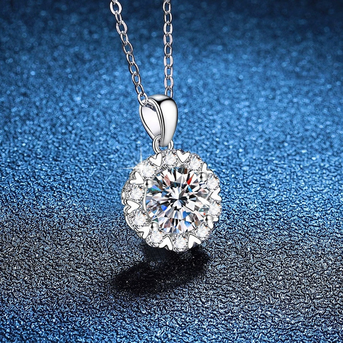 Floral Halo Moissanite Pendant Necklace in Platinum-Plated S925 Sterling Silver blue background angled view