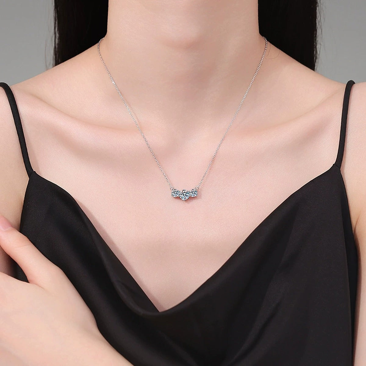 Three-Stone Moissanite Station Necklace in Platinum-Plated S925 Sterling Silver worn on neckline by model