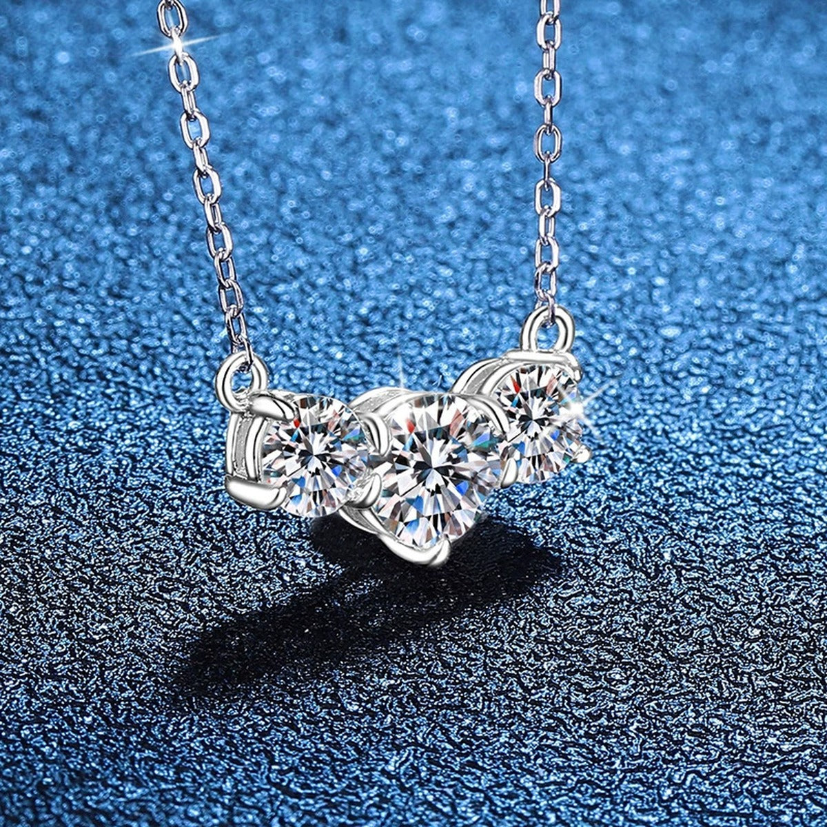 Three-Stone Moissanite Station Necklace in Platinum-Plated S925 Sterling Silver blue background angled view