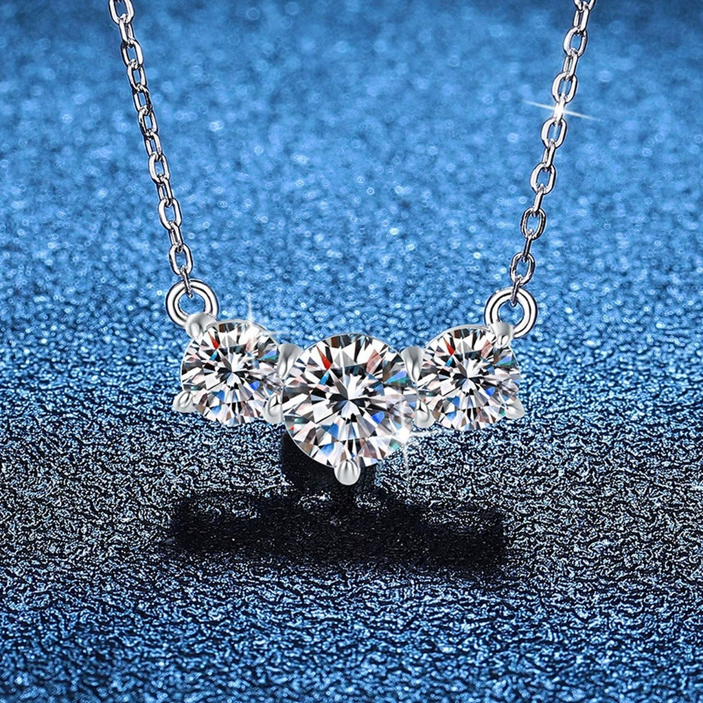 Three-Stone Moissanite Station Necklace in Platinum-Plated S925 Sterling Silver blue background close-up view
