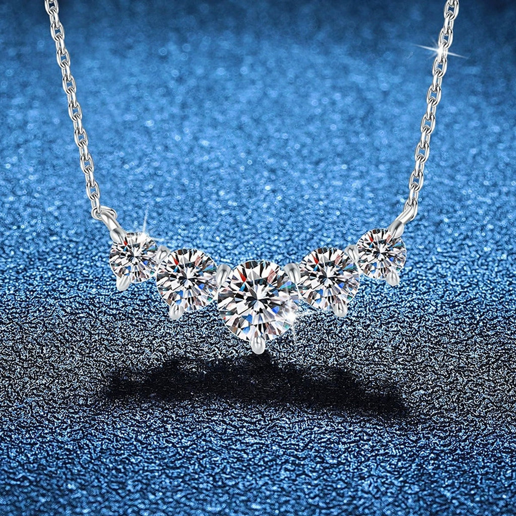 Five-Stone Graduated Moissanite Collar Necklace in Platinum-Plated S925 Sterling Silver blue background angled view