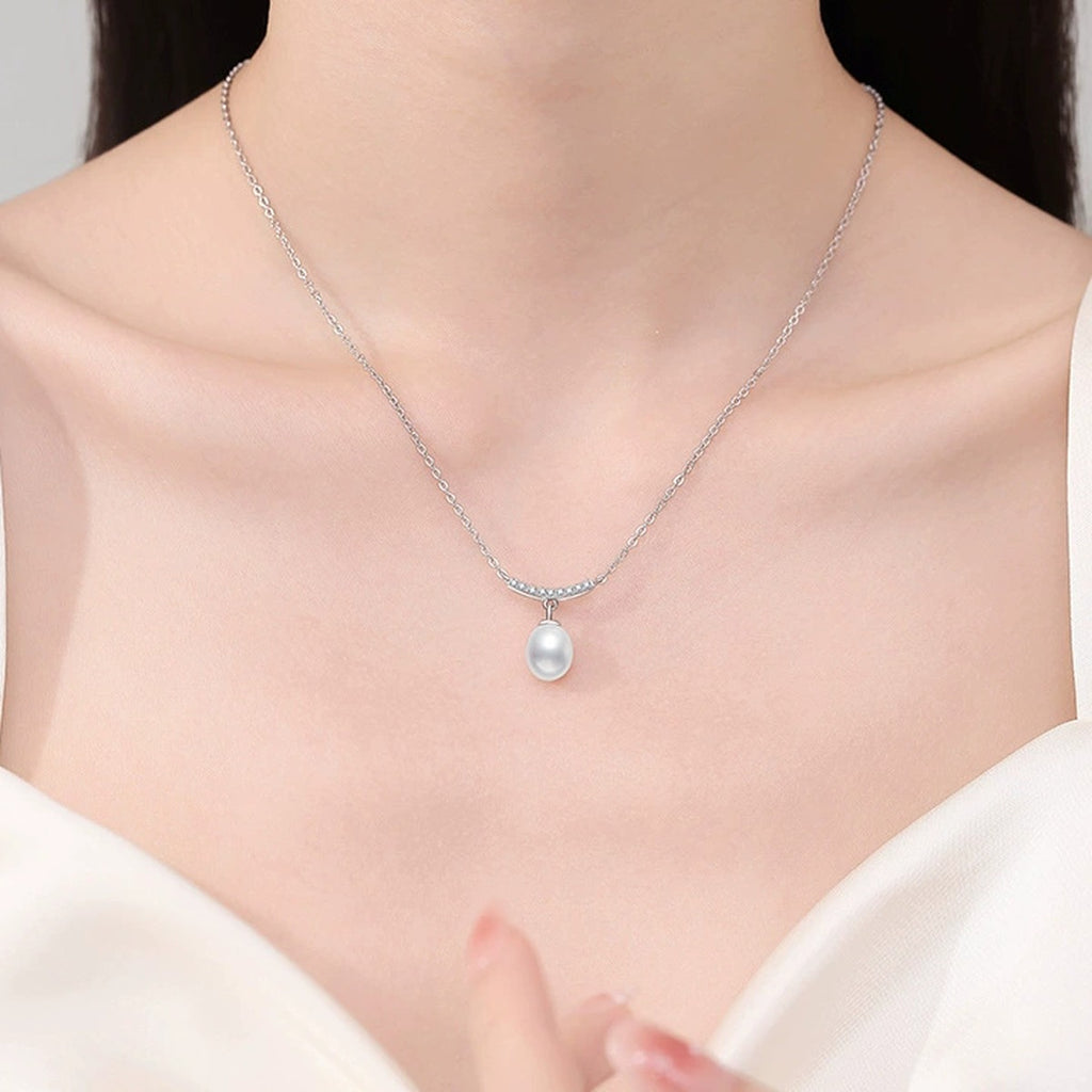 Curved Bar Moissanite Freshwater Pearl Pendant Necklace in White Gold-Plated S925 Sterling Silver worn on neckline by model