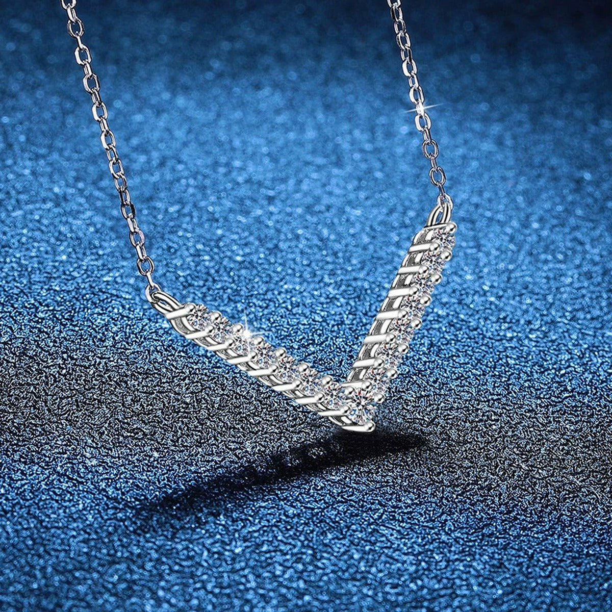 Chevron Moissanite Collar Necklace in Platinum-Plated S925 Sterling Silver blue background angled view