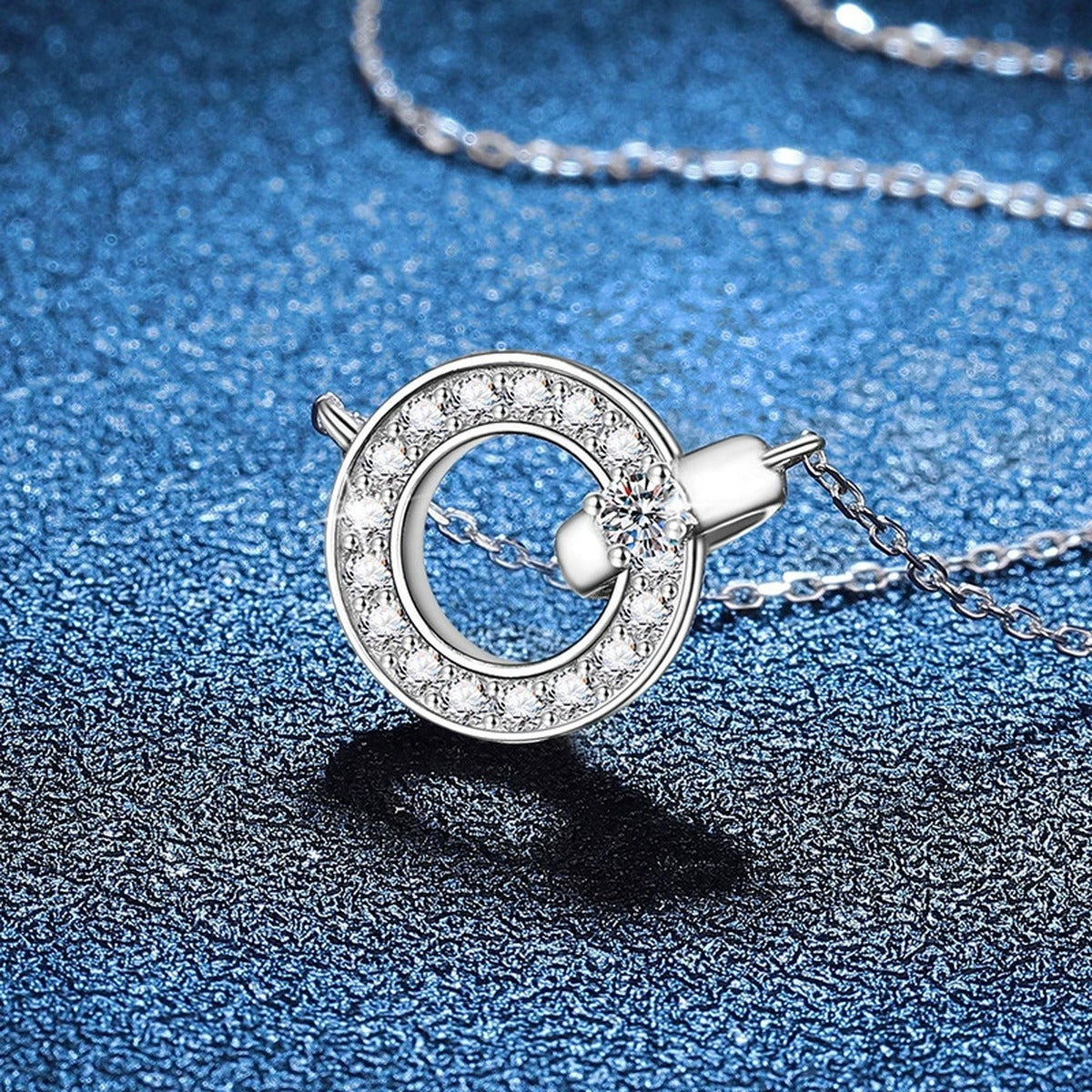 Circle Halo Moissanite Pendant Necklace in Platinum-Plated S925 Sterling Silver blue background close-up view