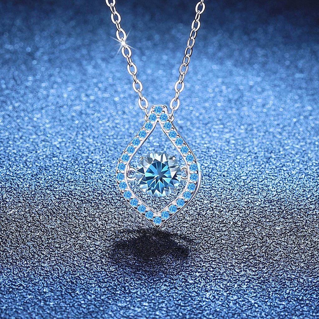 Blue Moissanite Teardrop Pendant Necklace in Platinum-Plated S925 Sterling Silver blue background close-up view
