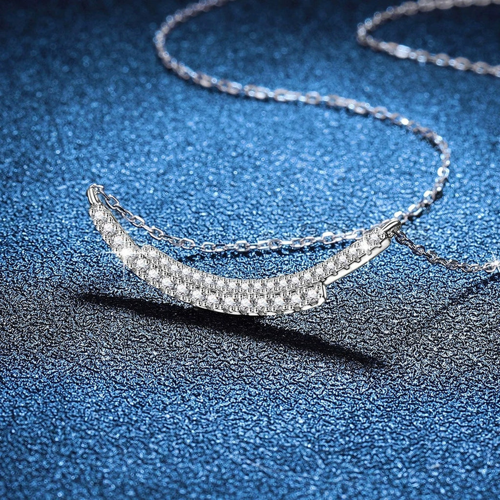 Curved Moissanite Bar Necklace in Platinum-Plated S925 Sterling Silver blue background angled view