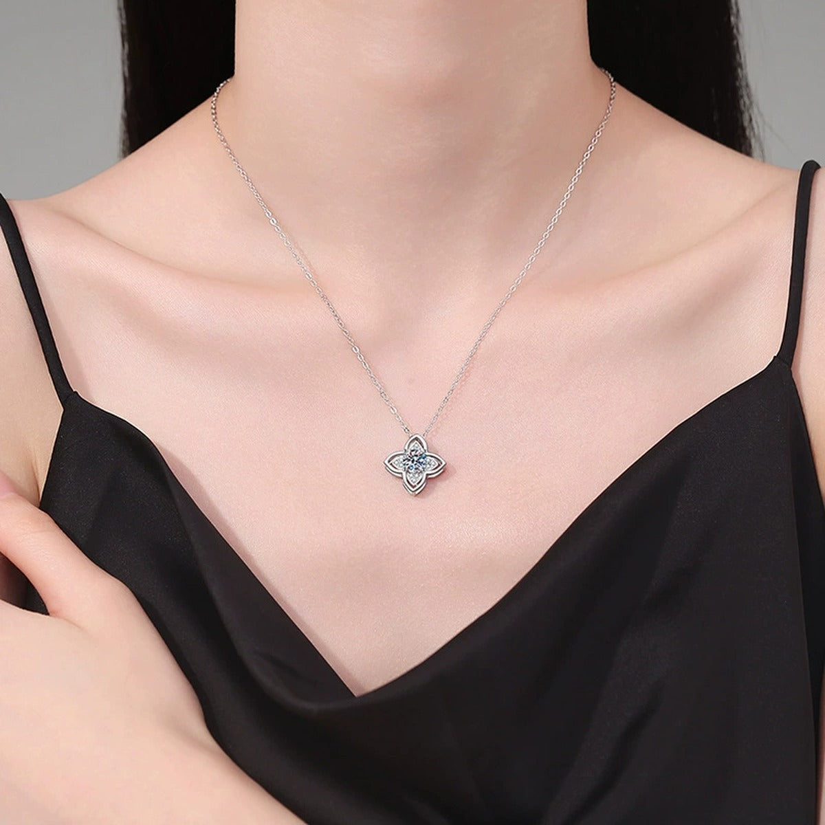 Four-Petal Halo Moissanite Pendant Necklace in Platinum-Plated S925 Sterling Silver worn on neckline by model
