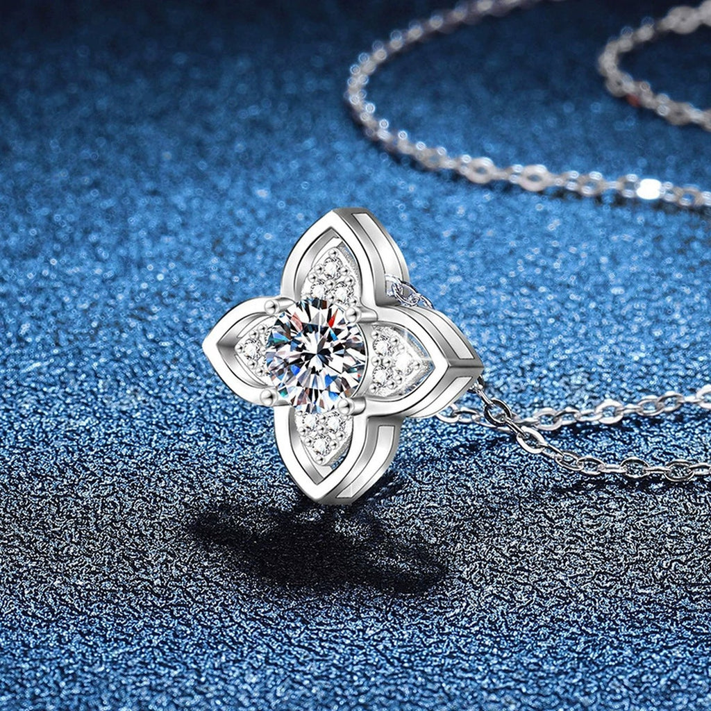 Four-Petal Halo Moissanite Pendant Necklace in Platinum-Plated S925 Sterling Silver blue background angled view