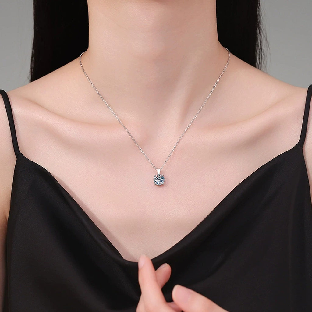 Round Solitaire Moissanite Pendant Necklace in S925 Sterling Silver worn on neckline by model