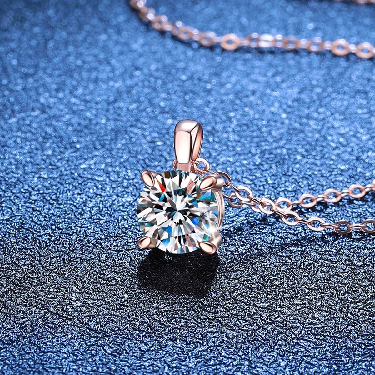 Round Solitaire Moissanite Pendant Necklace in S925 Sterling Silver blue background angled view