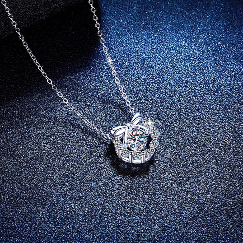 Bow Halo Moissanite Pendant Necklace with Cubic Zirconia in Platinum-Plated S925 Sterling Silver blue background angled view