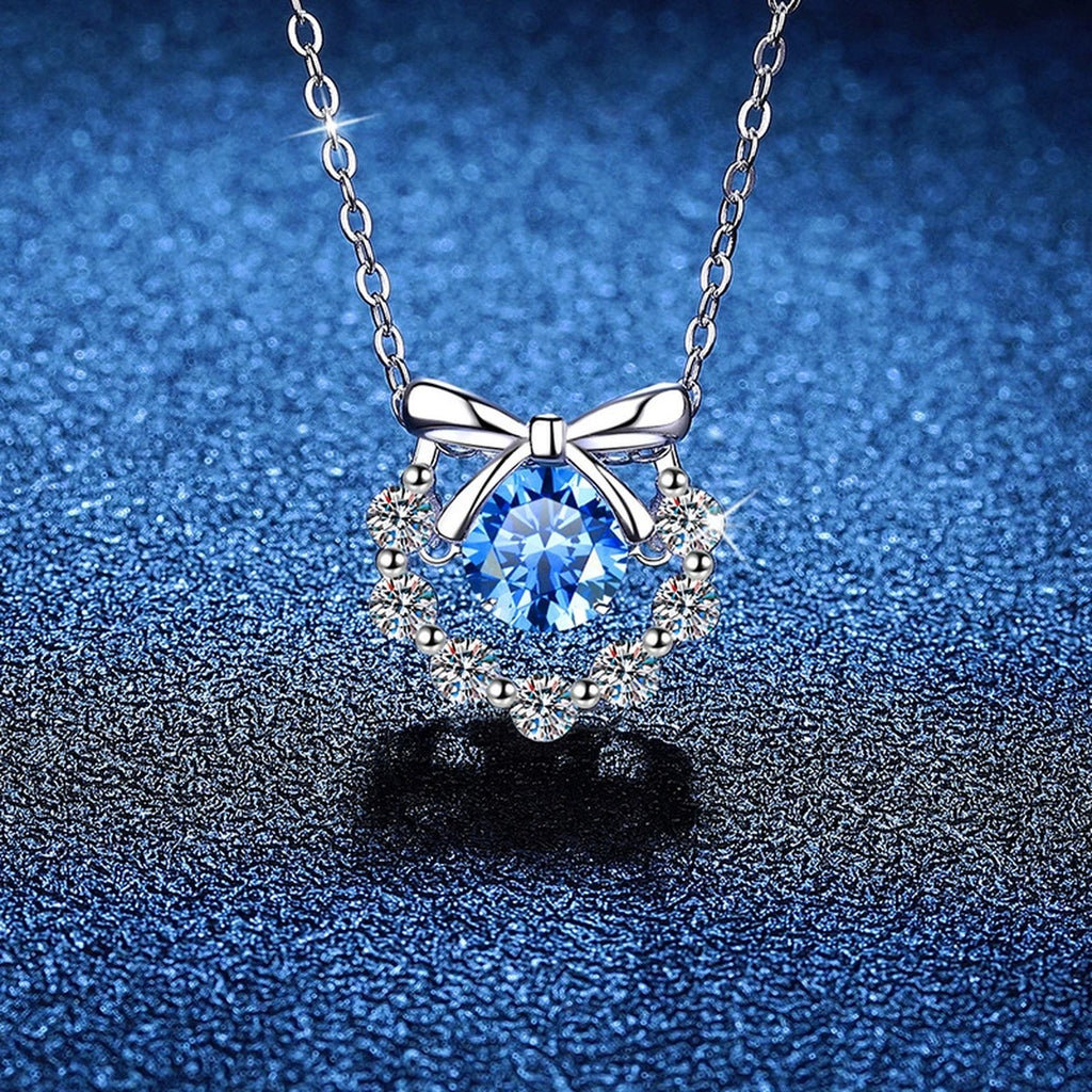 Bow Halo Moissanite Pendant Necklace with Cubic Zirconia in Platinum-Plated S925 Sterling Silver blue background close-up view