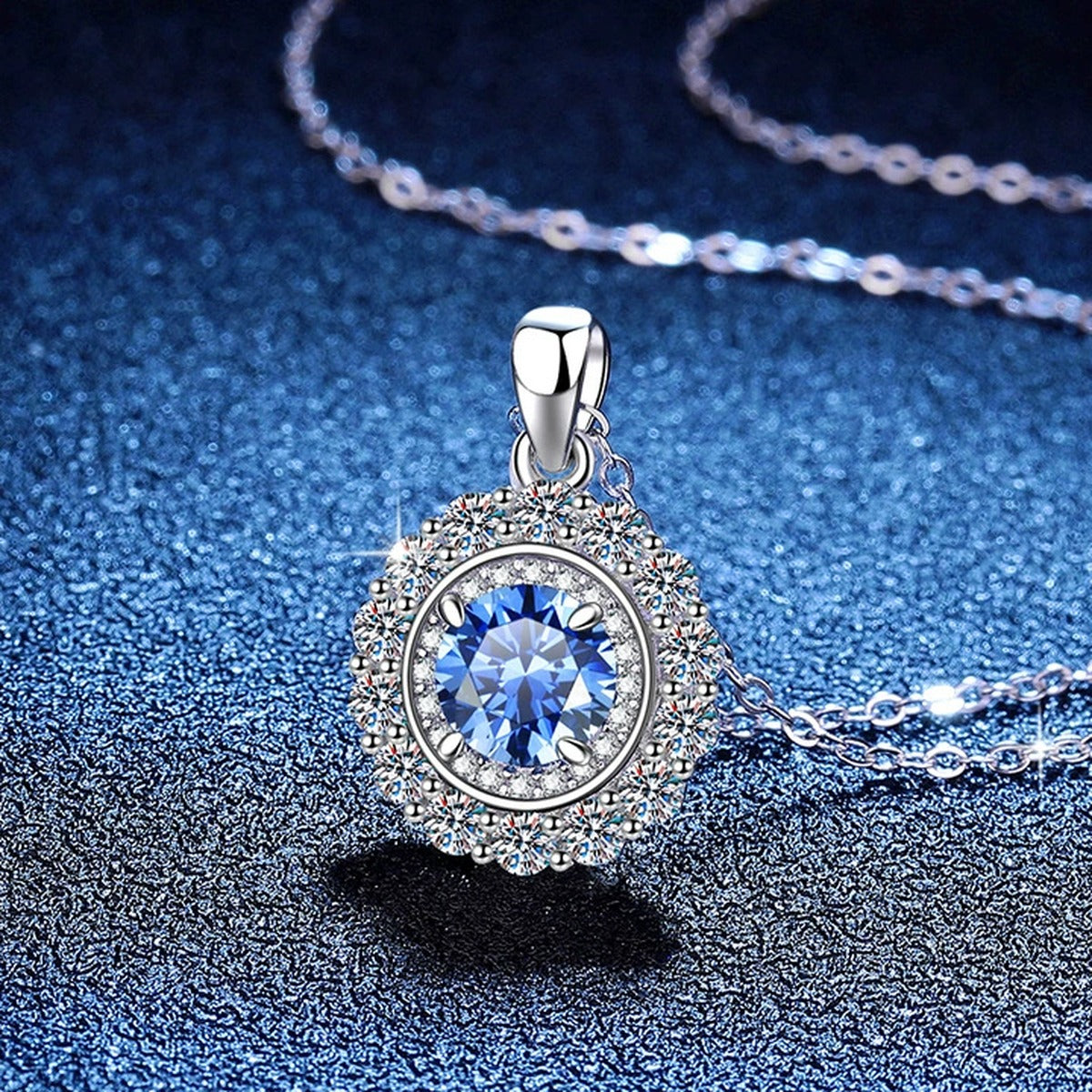 Colored Moissanite Halo Pendant Necklace in Platinum-Plated S925 Sterling Silver blue background close-up view