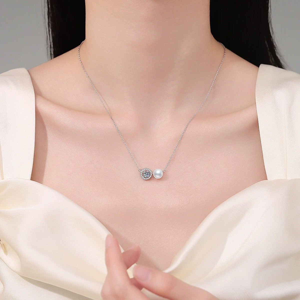 Two-Stone Moissanite Freshwater Pearl Pendant Necklace with Cubic Zirconia in White Gold-Plated S925 Sterling Silver worn on neckline by model