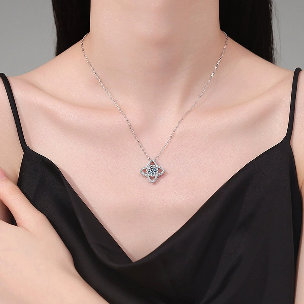 Four-Petal Halo Moissanite Pendant Necklace with Cubic Zirconia in Platinum-Plated S925 Sterling Silver worn on neckline by model