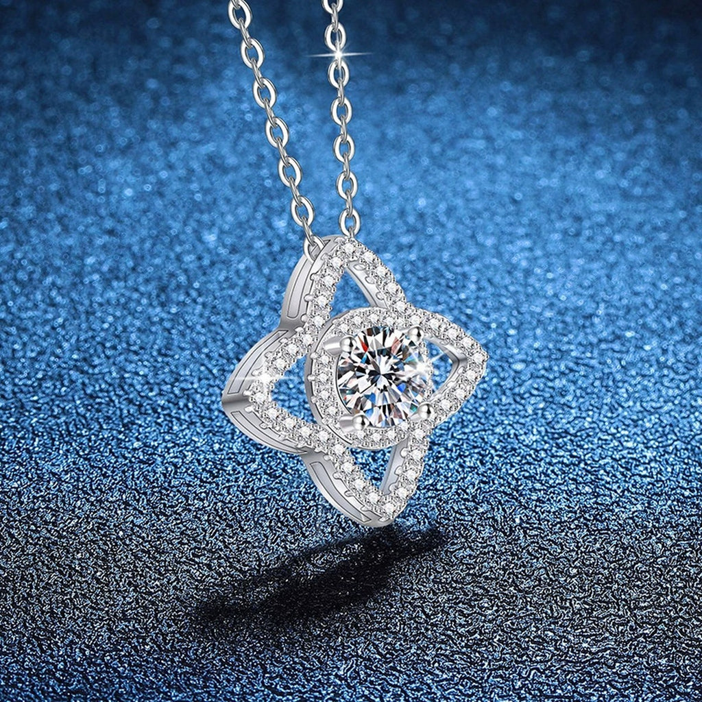 Four-Petal Halo Moissanite Pendant Necklace with Cubic Zirconia in Platinum-Plated S925 Sterling Silver blue background angled view