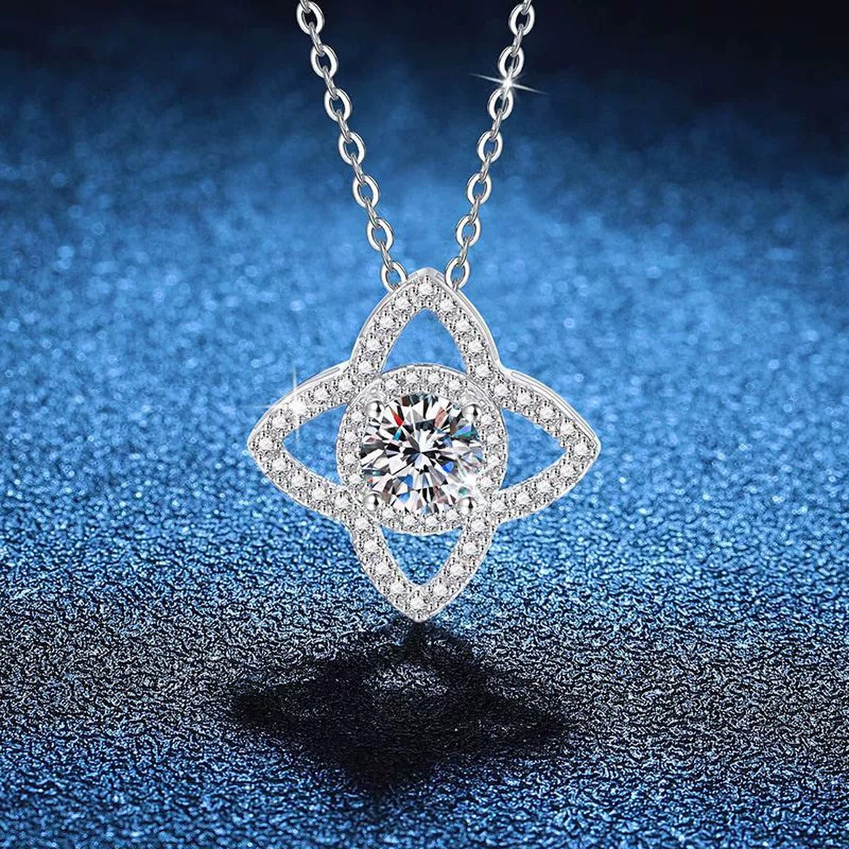 Four-Petal Halo Moissanite Pendant Necklace with Cubic Zirconia in Platinum-Plated S925 Sterling Silver blue background close-up view