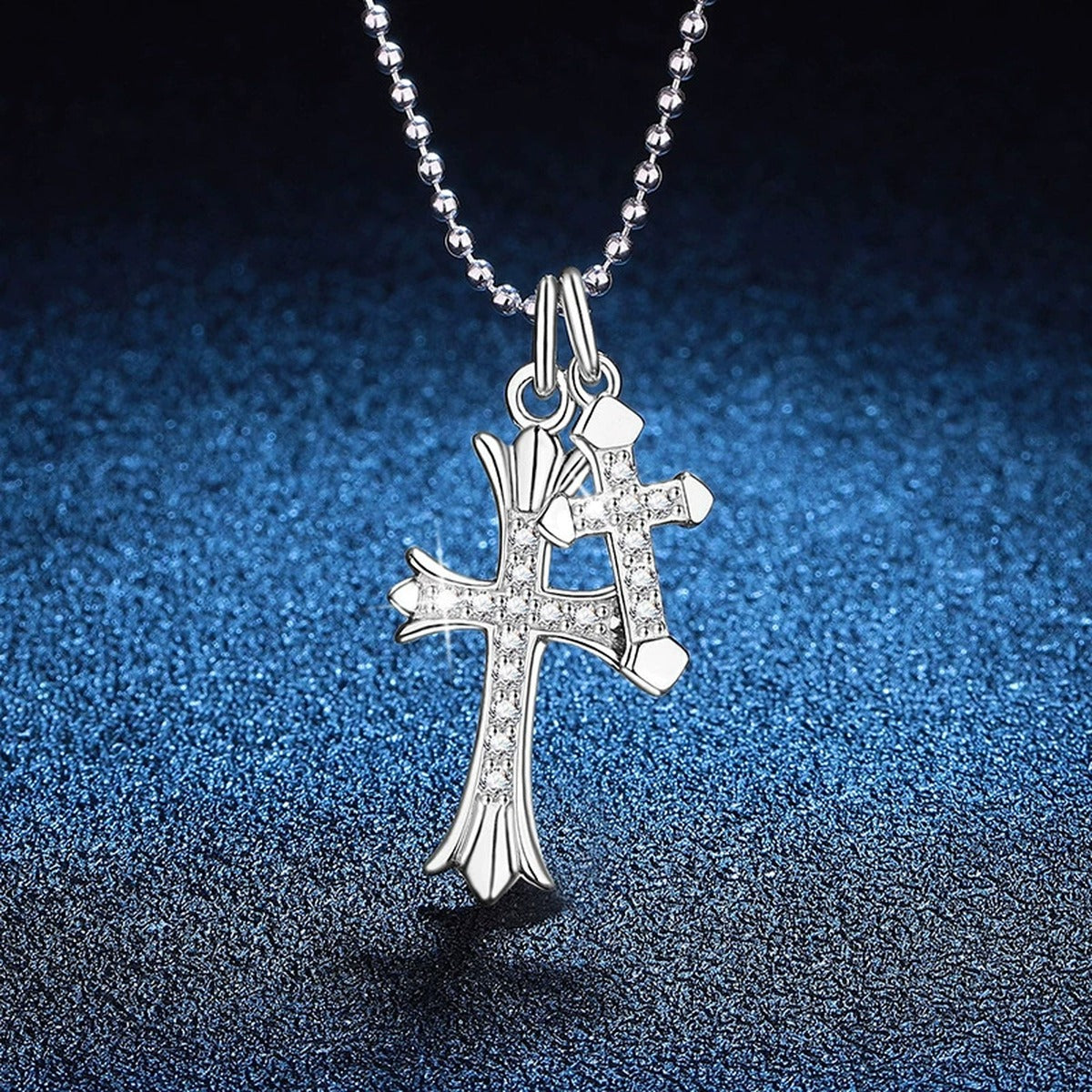 Cross Moissanite Pendant Necklace in Platinum-Plated S925 Sterling Silver blue background angled view