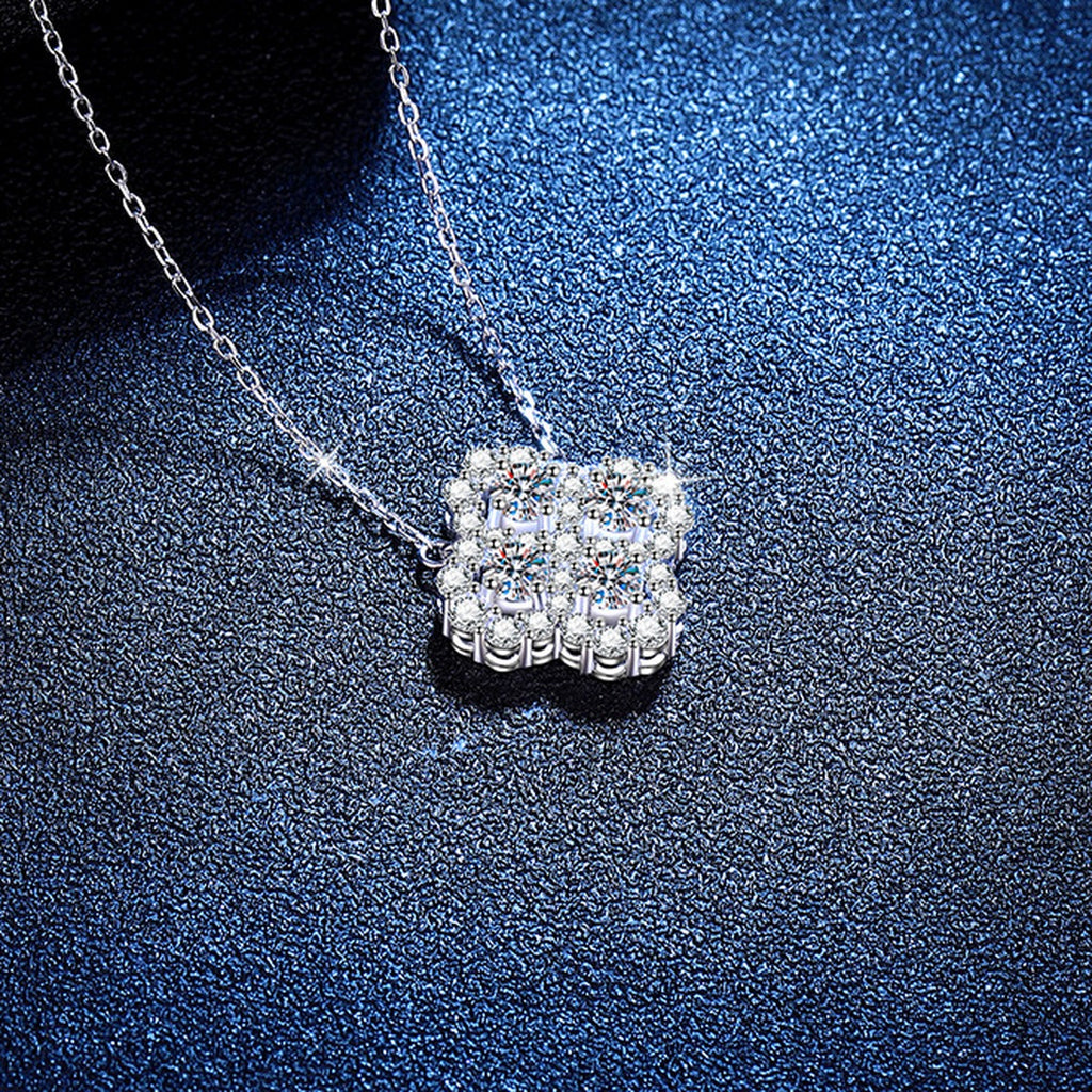 Four-Leaf Clover Moissanite Pendant Necklace with Cubic Zirconia in Platinum-Plated S925 Sterling Silver blue background angled view