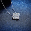 Four-Leaf Clover Moissanite Pendant Necklace with Cubic Zirconia in Platinum-Plated S925 Sterling Silver blue background angled view