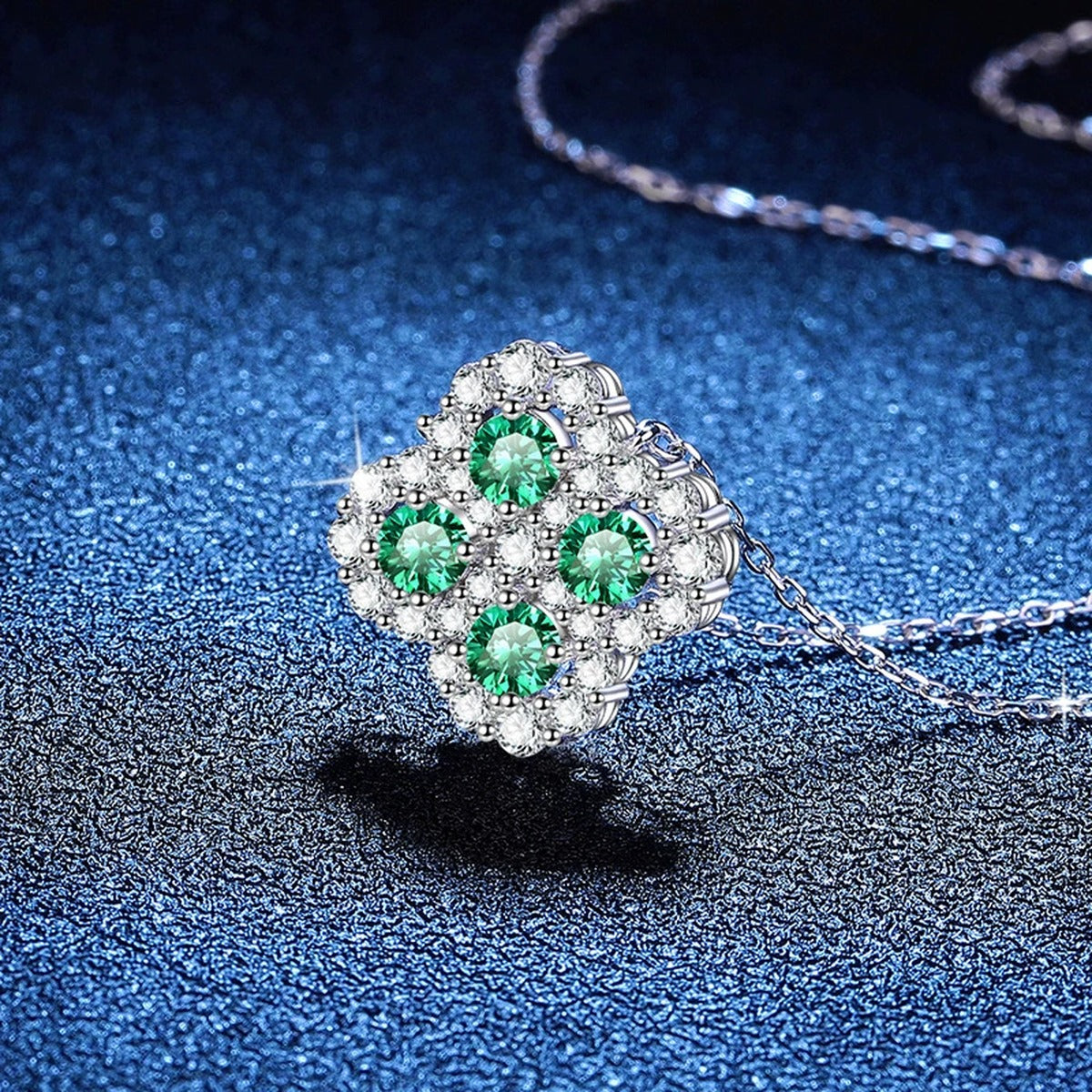 Four-Leaf Clover Moissanite Pendant Necklace with Cubic Zirconia in Platinum-Plated S925 Sterling Silver blue background close-up view