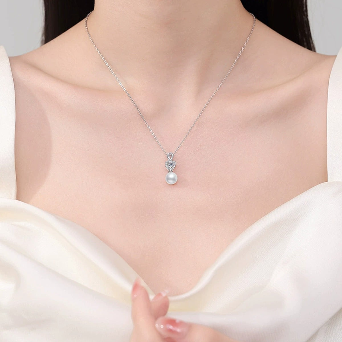 Crown Moissanite Freshwater Pearl Pendant Necklace with Cubic Zirconia in White Gold-Plated S925 Sterling Silver worn on neckline by model