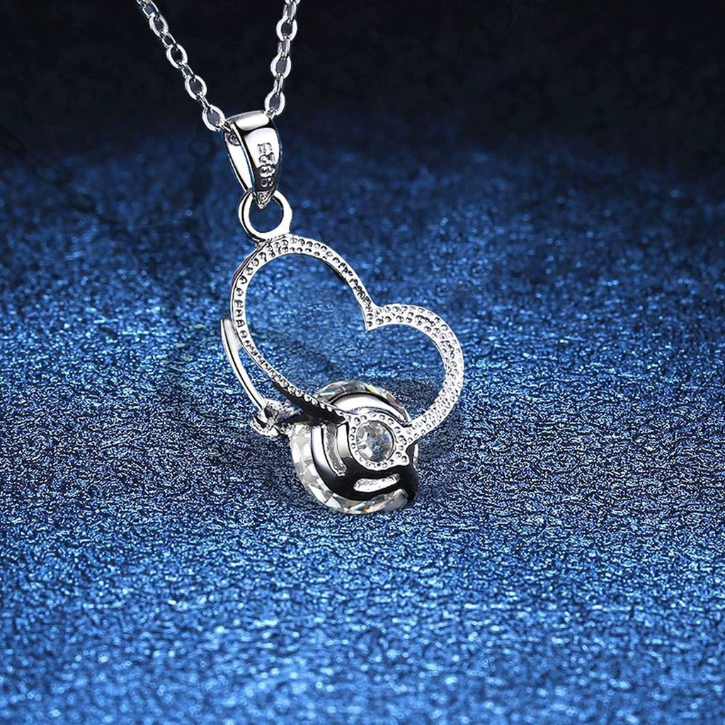 Open Heart Moissanite Pendant Necklace in Platinum-Plated S925 Sterling Silver blue background angled view