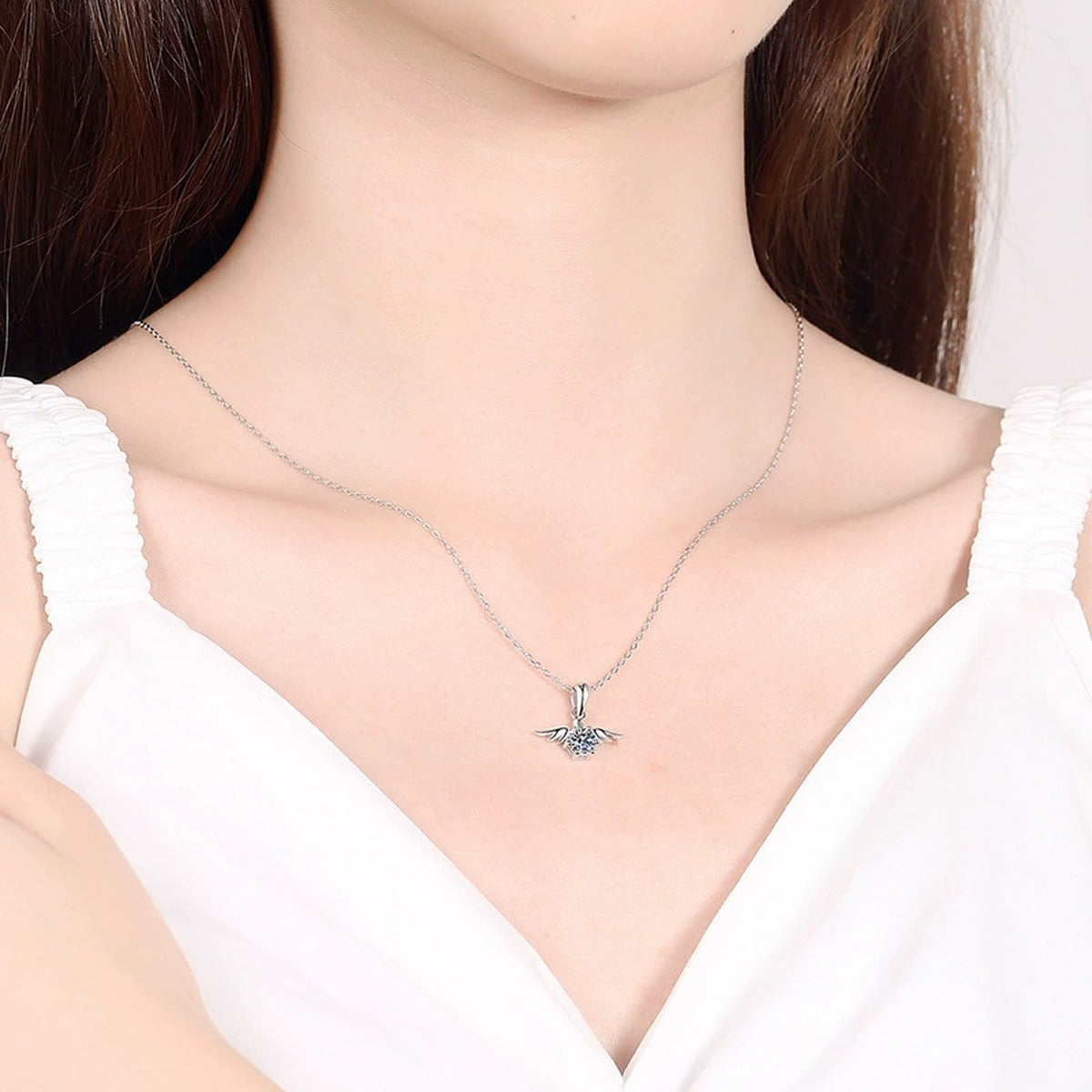 Angel Wing Moissanite Pendant Necklace in Platinum-Plated S925 Sterling Silver worn on neckline by model